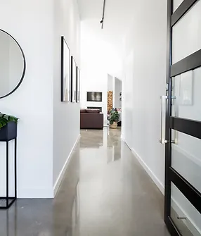 A hallway with a mirror and plants in it