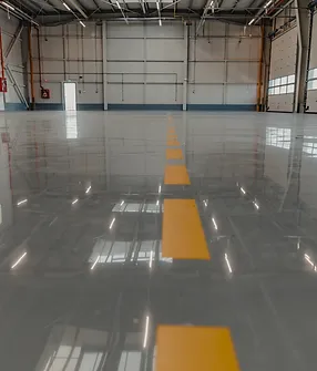 A warehouse with yellow lines painted on the floor.
