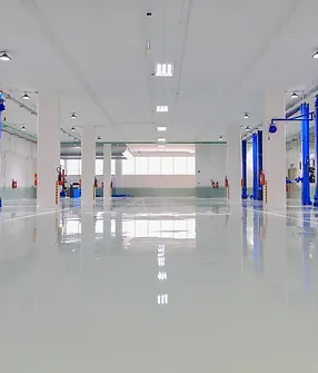 A white room with two blue lifts and a floor.