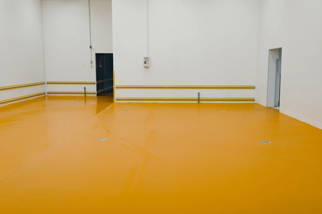 A room with yellow floor and white walls.