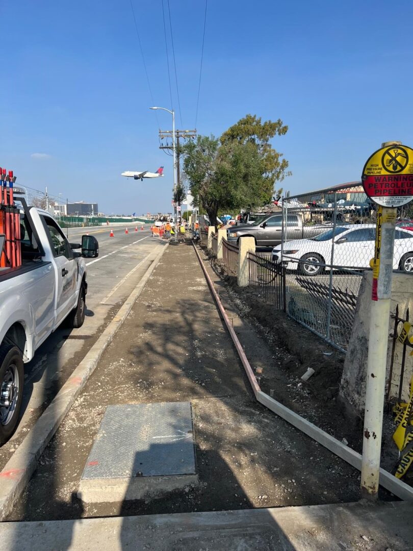 Sidewalk construction with a warning sign.