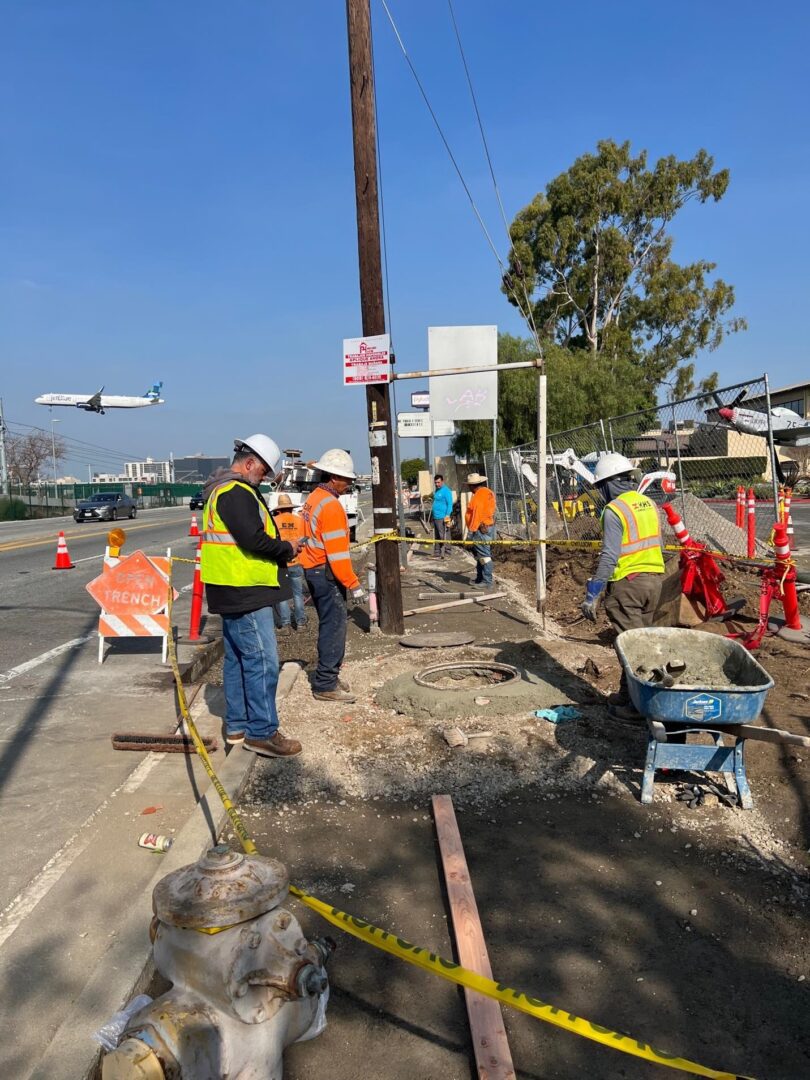 Construction workers working on a street.