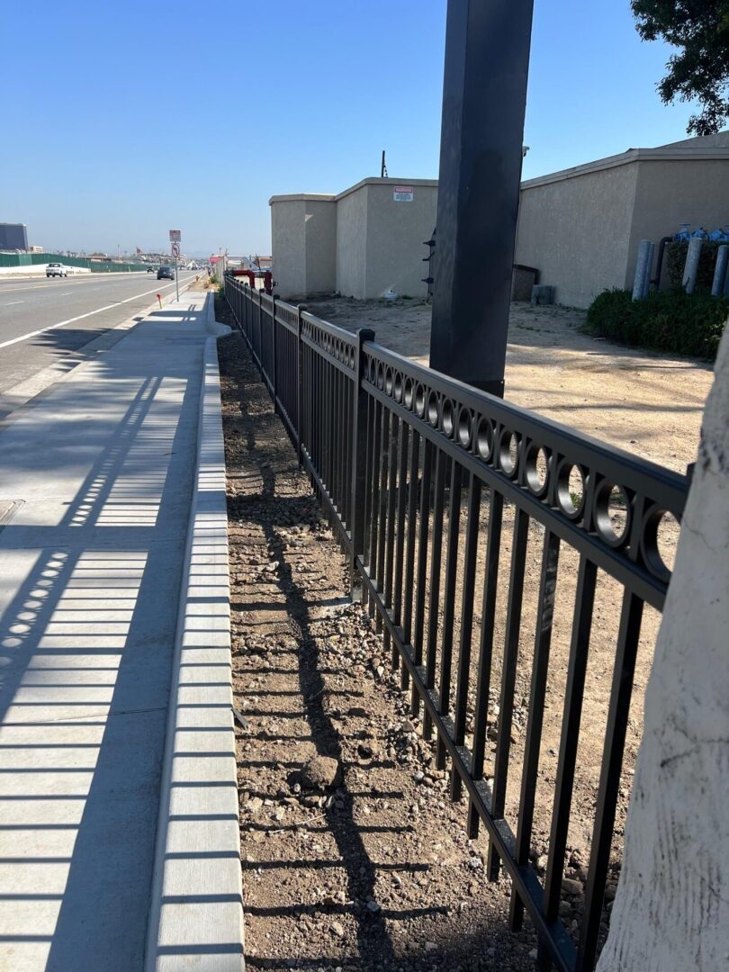 Black metal fence along sidewalk.