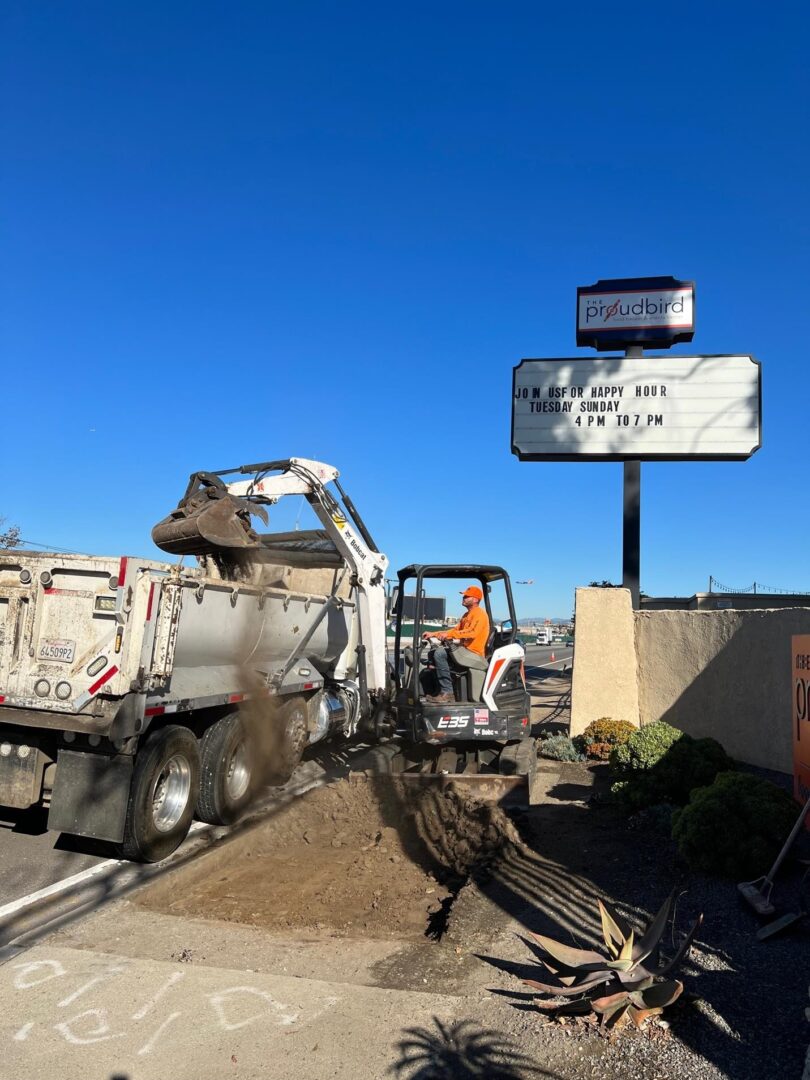 Dump truck and excavator loading dirt.