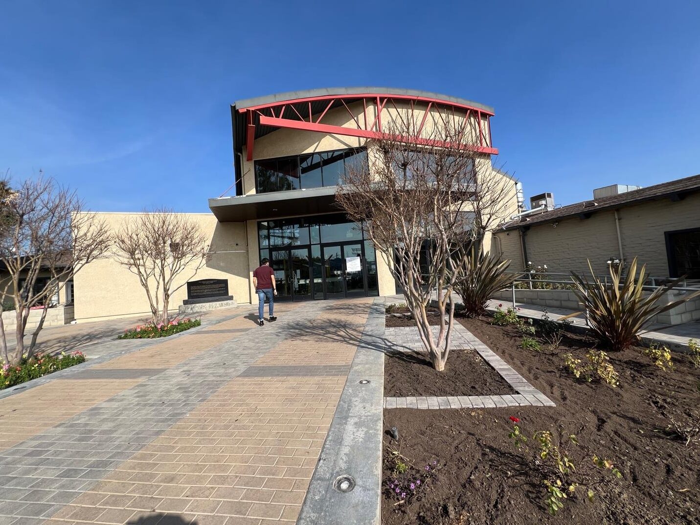 A man walks toward a building entrance.