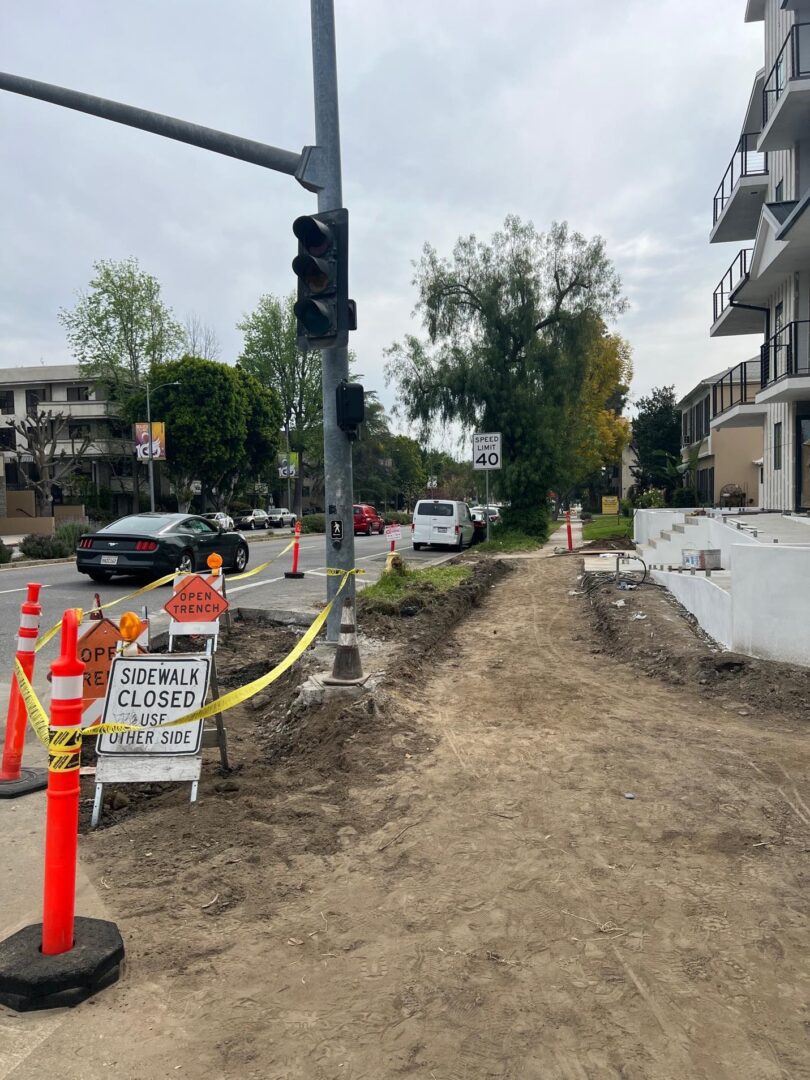 Sidewalk closed, use other side.