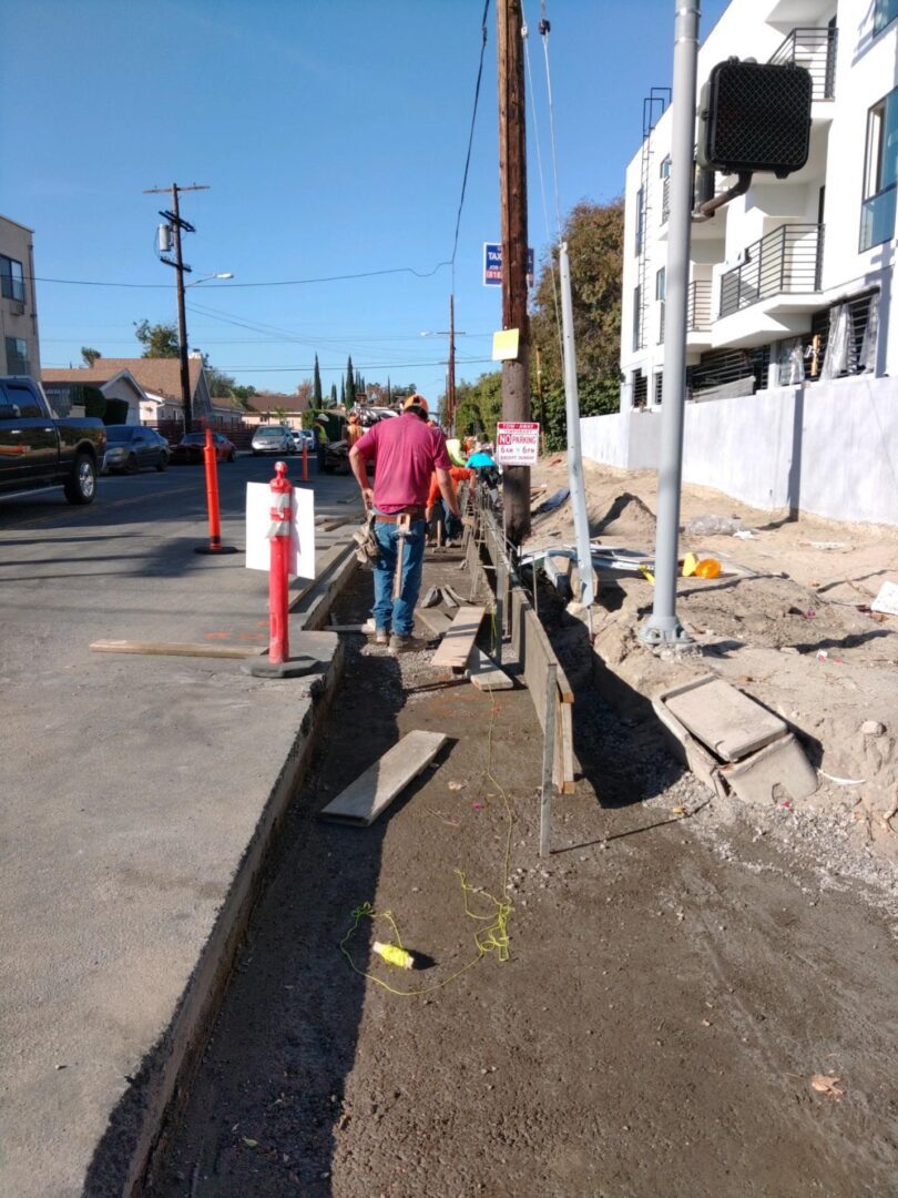 Construction workers building a sidewalk.