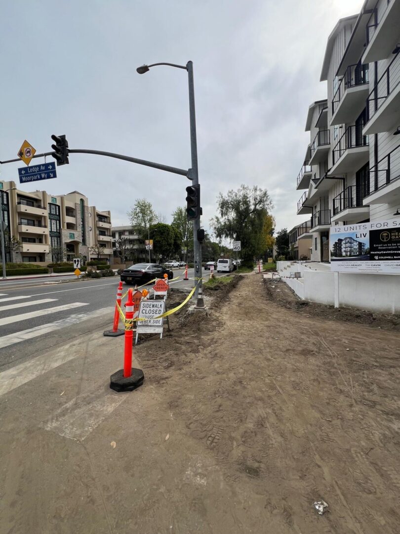 Street under construction with traffic lights.