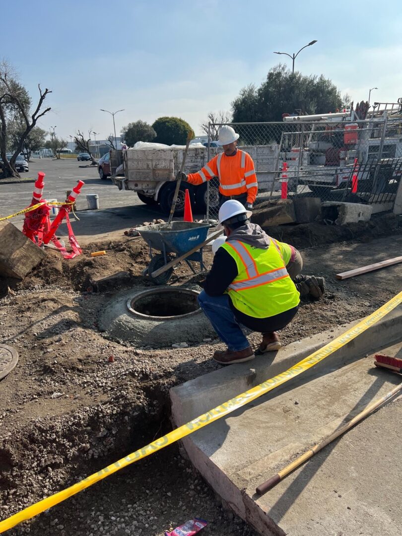 Construction workers repairing a manhole.