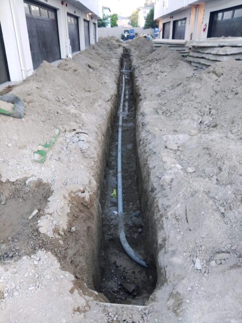 Trench with conduit for underground utilities.