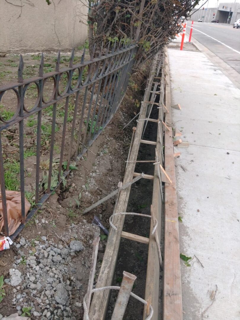 Concrete formwork next to a fence.